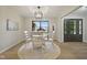 A dining area with a round table set on a patterned rug and illuminated by a modern light fixture at 4645 Quail Run Dr, New Palestine, IN 46163