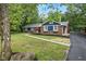 Charming brick home with blue accents, walkway, mature trees, and well-maintained landscaping at 4645 Quail Run Dr, New Palestine, IN 46163