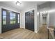 Entrance foyer featuring modern door, coat closet, and hardwood flooring at 4645 Quail Run Dr, New Palestine, IN 46163