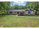 Beautiful brick home with blue accents, mature trees, and walkway leading to front door at 4645 Quail Run Dr, New Palestine, IN 46163