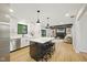 Island kitchen features quartz countertop, pendant lights, stainless steel appliances and opens to the Gathering room at 4645 Quail Run Dr, New Palestine, IN 46163
