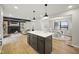 Renovated island kitchen with quartz countertops, pendant lighting and opens to the dining and Gathering rooms at 4645 Quail Run Dr, New Palestine, IN 46163