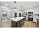 Island kitchen features quartz counters, stainless appliances, and opens to the dining and Gathering rooms at 4645 Quail Run Dr, New Palestine, IN 46163