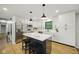 Island kitchen features quartz counters, pendant lights, stainless appliances and ample cabinet space at 4645 Quail Run Dr, New Palestine, IN 46163