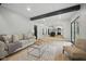 Bright living room with wood beam, light wood floors and a view into the renovated kitchen at 4645 Quail Run Dr, New Palestine, IN 46163