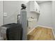 The utility room has storage cabinets and a utility sink along with vinyl flooring and a water filtration system at 4645 Quail Run Dr, New Palestine, IN 46163