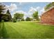 Expansive backyard featuring lush green lawn and mature trees, ideal for outdoor activities at 4901 E County Road 100 N, Avon, IN 46123