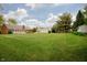 Spacious backyard view showcases lush lawn, home, garage, and quaint shed at 4901 E County Road 100 N, Avon, IN 46123