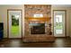 Living room brick fireplace with a decorative mantel and doors to the outdoor porch at 4901 E County Road 100 N, Avon, IN 46123