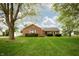 Charming brick ranch home featuring a well-manicured lawn and mature trees at 4901 E County Road 100 N, Avon, IN 46123
