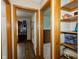 Inviting hallway showcasing beautiful wood floors and an adjacent room with a bookcase at 4901 E County Road 100 N, Avon, IN 46123