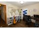 Home office with world map, guitar, and bookshelves at 4901 E County Road 100 N, Avon, IN 46123