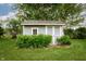 Charming backyard shed surrounded by manicured landscaping and lush greenery at 4901 E County Road 100 N, Avon, IN 46123