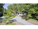 A high angle view of a home with an extensive gravel driveway and mature trees at 496 N County Road 325 W, Danville, IN 46122