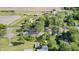 This aerial view highlights a serene rural property, featuring a farmhouse, mature trees and open fields at 496 N County Road 325 W, Danville, IN 46122