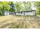 Expansive backyard with lush lawn, shade trees, and a pristine white-painted house at 496 N County Road 325 W, Danville, IN 46122