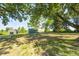 The backyard features a well-maintained lawn and shed, shaded by mature trees at 496 N County Road 325 W, Danville, IN 46122