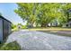Landscaped backyard features crushed rock, a large shed, and is shaded by mature trees at 496 N County Road 325 W, Danville, IN 46122