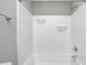 Bright white bath tub and shower combination with shelving and modern fixtures at 496 N County Road 325 W, Danville, IN 46122