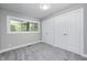 Bedroom with a large window and gray carpet next to a closet with double doors at 496 N County Road 325 W, Danville, IN 46122