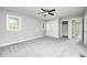 Neutral bedroom featuring carpet, ceiling fan, closet, and a large window at 496 N County Road 325 W, Danville, IN 46122