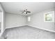 This bedroom features neutral walls, carpet, a ceiling fan, and bright windows at 496 N County Road 325 W, Danville, IN 46122