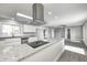 Modern kitchen with white cabinets, granite countertops, stainless steel appliances, and sleek hood vent at 496 N County Road 325 W, Danville, IN 46122