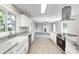 Open kitchen design with new cabinets, granite counters, and stainless-steel appliances at 496 N County Road 325 W, Danville, IN 46122