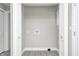 Bright laundry room boasts gray vinyl flooring, utility connections, and double door access at 496 N County Road 325 W, Danville, IN 46122