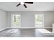 Spacious living room featuring large windows, neutral walls, and modern vinyl flooring at 496 N County Road 325 W, Danville, IN 46122