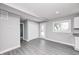 Bright living room features gray walls, sleek gray floors, and a door to the backyard, seamlessly blending indoor and outdoor spaces at 496 N County Road 325 W, Danville, IN 46122