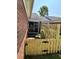 Landscaped backyard featuring a wooden fence, small gate, and walkway at 5491 Vin Rose Ln, Lawrence, IN 46226