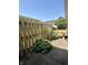 Landscaped side yard and walkway featuring a birdbath and wooden fence at 5491 Vin Rose Ln, Lawrence, IN 46226
