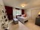 Cozy bedroom with a daybed, decorative ladder, and ample natural light from the window at 5491 Vin Rose Ln, Lawrence, IN 46226