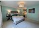 A spacious bedroom featuring a tufted headboard and view into a custom walk-in closet at 5491 Vin Rose Ln, Lawrence, IN 46226
