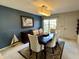 An elegant dining room featuring a dark wood table, upholstered chairs, and contemporary lighting at 5491 Vin Rose Ln, Lawrence, IN 46226