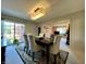 Elegant dining room with modern chandelier and large sliding glass door, adjacent to the living room at 5491 Vin Rose Ln, Lawrence, IN 46226