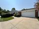 A well-maintained home featuring a brick facade, a two-car garage, and a concrete driveway at 5491 Vin Rose Ln, Lawrence, IN 46226