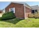 Exterior view of the home with a well-maintained lawn and lush greenery at 5491 Vin Rose Ln, Lawrence, IN 46226