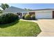 A well-maintained home with a green lawn, bushes, brick facade, and a two-car garage at 5491 Vin Rose Ln, Lawrence, IN 46226