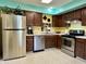 Bright kitchen showcasing stainless steel appliances, including a large refrigerator and updated fixtures at 5491 Vin Rose Ln, Lawrence, IN 46226