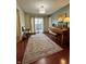 Inviting living room with piano, stylish rug, and access to outdoor space through sliding glass doors at 5491 Vin Rose Ln, Lawrence, IN 46226