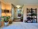Inviting living room showing an entry, a ladder-style bookshelf, and a view of the dining area at 5491 Vin Rose Ln, Lawrence, IN 46226