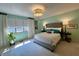 Serene main bedroom with large windows, stylish chandelier, and neutral color palette at 5491 Vin Rose Ln, Lawrence, IN 46226