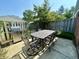Outdoor patio featuring a grill, outdoor furniture set and a wooden privacy fence at 5491 Vin Rose Ln, Lawrence, IN 46226