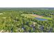 Aerial view showcases a home nestled in a lush, green landscape near a lake at 5570 Paradise Ct, Martinsville, IN 46151