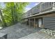 Spacious backyard featuring a stone patio, well-kept greenery, and lower deck at 5570 Paradise Ct, Martinsville, IN 46151