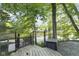 Scenic backyard featuring a wooded gate leading to waterfront and green trees at 5570 Paradise Ct, Martinsville, IN 46151