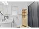 Well-lit bathroom with updated vanity, faucet, wood storage cabinet, and black shower curtain at 5570 Paradise Ct, Martinsville, IN 46151