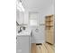 Well-lit bathroom with updated vanity, faucet, wood storage cabinet, and updated tile at 5570 Paradise Ct, Martinsville, IN 46151